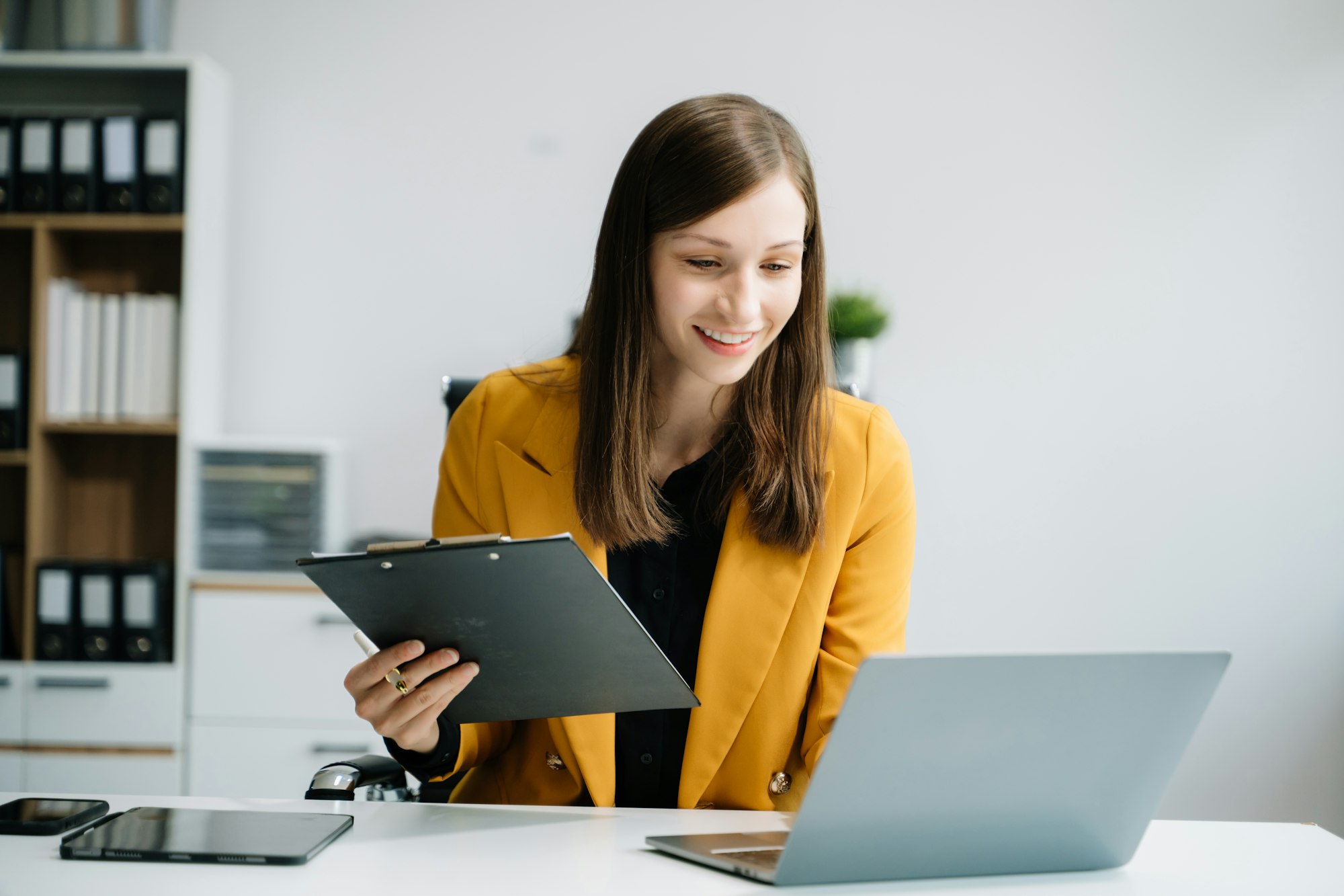 Business woman sitting at a desk using a laptop computer Navigating Finance and Marketing