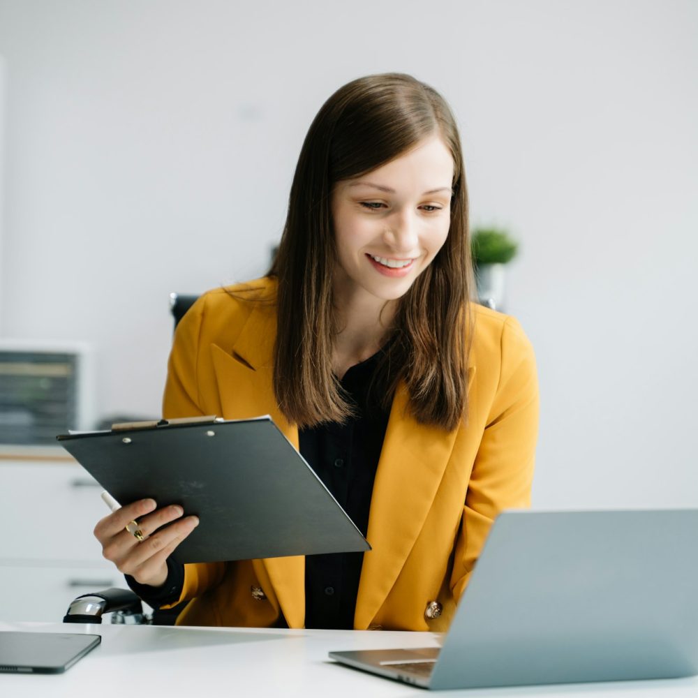 Business woman sitting at a desk using a laptop computer Navigating Finance and Marketing