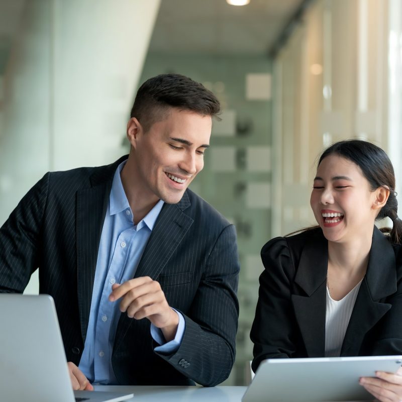 Happy two business people discuss investment project working and planning strategy. Businessman and